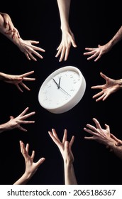 A Crowd Of People Is Drawn To The Clock In The Center. Hands Close-up. Black Background. Vertical. The Concept Of Stress, Greed And Haste.