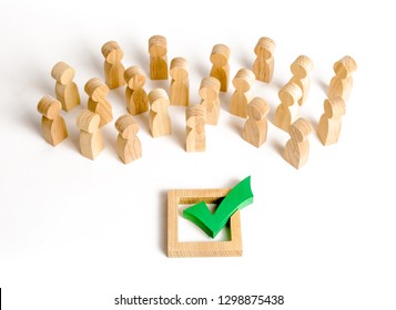 A crowd of people looks at a green check mark. Voting and election concept. Referendum, revolution. Forcible overthrow. Making the right decision, majority agreement. Peace and order, legitimization. - Shutterstock ID 1298875438