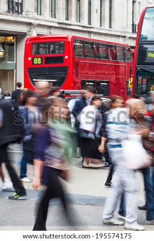 crowd of people in motion blur crossing the Oxford Circus in London