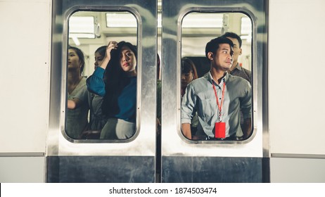 Crowd of people on a busy crowded public subway train travel . Commuting and urban lifestyle concept .