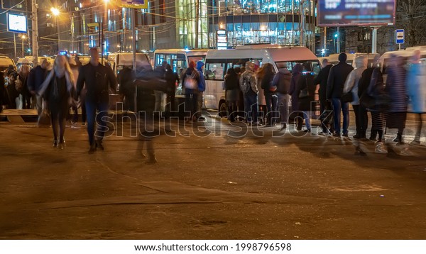 The crowd of people in the queue for\
the bus at rush hour  in the end of the working\
day