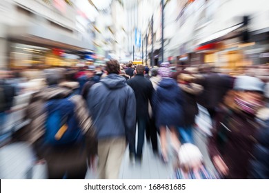 Crowd Of People In The Shopping Street Of A City With Intentional Zoom Effect