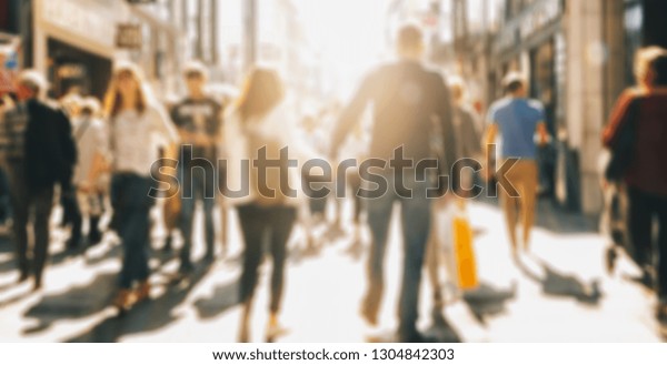 crowd of people in a shopping street,
defocused background