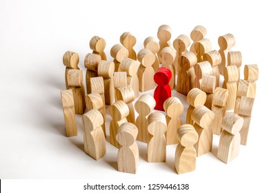 A crowd of people surrounded the red man. Accusation of crime, mob law over a person, lynch court. The leader in the center, the leader, an example for diving. Angry crowd - Shutterstock ID 1259446138