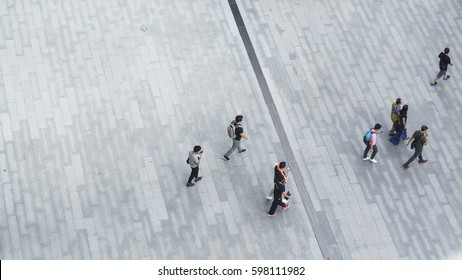 Crowd Of People Walk On Open Space Concrete Pavement From Top View ,bird Eye View