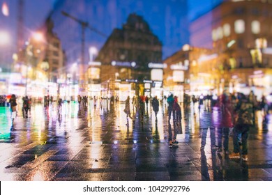 Crowd Of People Walking On Rainy City Streets By Night