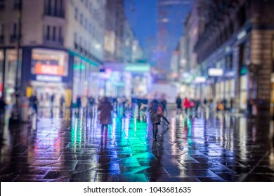 crowd of people walking on rainy night in the city  - Powered by Shutterstock