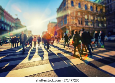 crowd of people walking on sunny streets