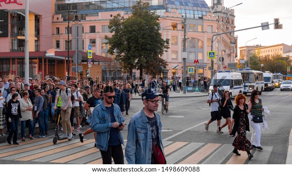 A Crowd Of Protesters Crosses The Road. Protesters Are Escorted By ...