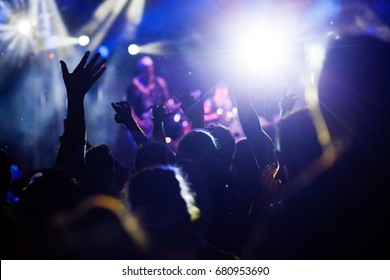 crowd with raised hands at concert - summer music festival - Shutterstock ID 680953690