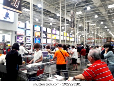 Crowd In Shopping Mall, Queuing At The Checkout Counter To Check Out.backdrop And Design Element Use. Defocused Background With Bokeh Light.