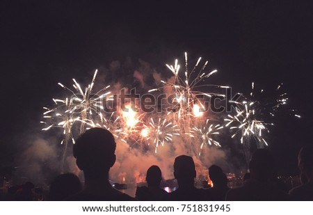 Crowd of Silhouetted People Watching a Fireworks Display for New Years or Fourth of July Celebration, Horizontal