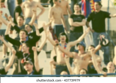 crowd of soccer fans at the stadium - defocused background - football conceppt