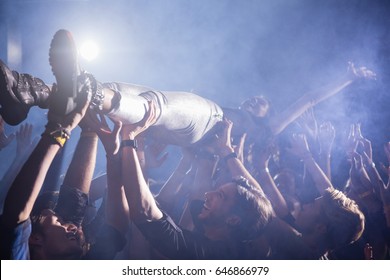 Crowd Surfing At A Concert In Nightclub