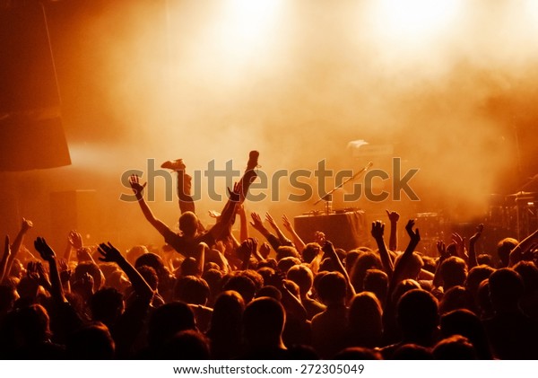 Crowd surfing during\
a musical performance