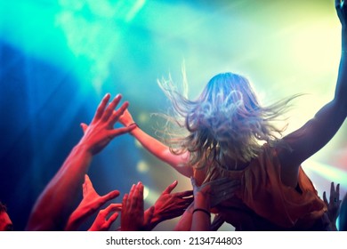 Crowd Surfing. A Young Girl Crowd Surfing As A Band Plays One Of Her Favourite Songs.