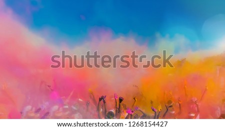 Crowd throwing bright coloured powder paint in the air, Holi Festival Dahan	