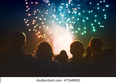 Crowd watching fireworks and celebrating - Shutterstock ID 477649855