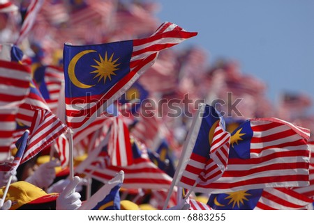 Crowd waving Malaysian flag