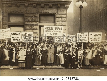 Crowd of women's suffrage supporters demonstrating with signs reading, 'Wilson Against Women,' in Chicago on October 20, 1916. Wilson withheld his support for Votes of Women until 1918.