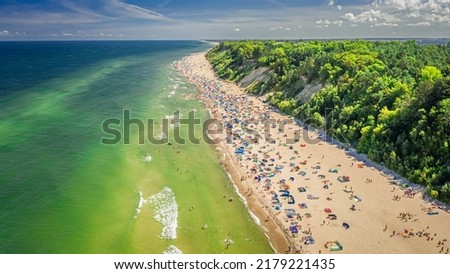 Crowded beach at Baltic Sea in Poland, Europe. Tourism at sea.