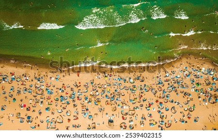 Similar – Luftaufnahme von fliegenden Drohnen von Menschen, die sich am Algarve Beach in Portugal entspannen.