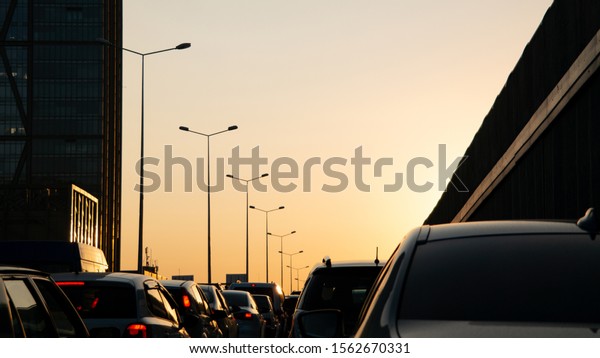 crowded car\
traffic at work exit time at\
sunset