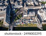 Crowded city centre during the Galway Arts Festival. Pegasus Parade concludes at the Spanish Arch. Aerial top-down view