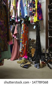 Crowded Clothing Racks And Piled Shoes In Second Hand Store