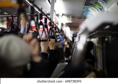 Crowded commuter train in Japan at rush hour in the evening. - Shutterstock ID 698738395