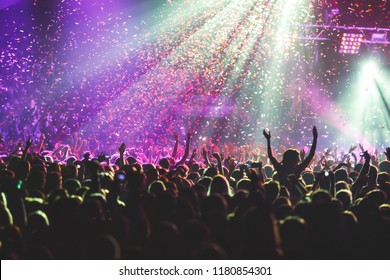 A Crowded Concert Hall With Scene Stage Lights, Rock Show Performance, With People Silhouette
