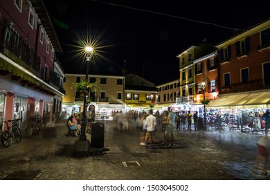 Crowded Marketplace In The Town Center At Night. Caorle, Italy.