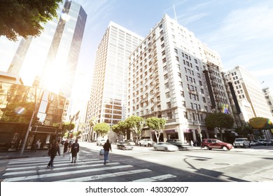 Crowded People On Road Intersection In Downtown Of Los Angeles At Sunrise