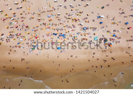 Similar – Luftaufnahme von fliegenden Drohnen von Menschen, die sich am Algarve Beach in Portugal entspannen.