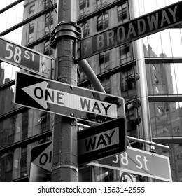 Crowded street sign in Manhattan, New York City, including 58th street and Broadway.