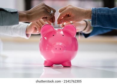 Crowdfunding Concept. People Inserting Coins Into Piggybank