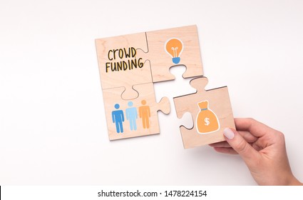 Crowdfunding concept. Woman connecting the last puzzle with money for idea on white background