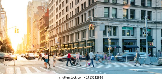 Crowds Of People In Motion Walking Across The Busy Intersection On 5th Avenue In Midtown Manhattan, New York City NYC