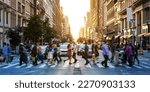Crowds of people walking across a busy crosswalk at the intersection of 23rd Street and 5th Avenue in Manhattan New York City NYC