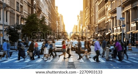 Crowds of people walking across a busy crosswalk at the intersection of 23rd Street and 5th Avenue in Manhattan New York City NYC