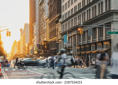 Crowds Of People Walking Down The Street At A Busy Intersection On 5th Avenue In New York City With Sunset Light Shining In The Background