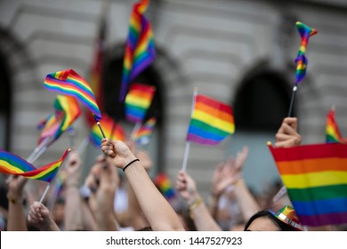 Crowds Of People Wave Gay Pride Flags At A Solidarity March