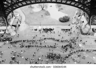 Crowds under Eiffel Tower in Paris France