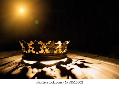 The crown on a black background is illuminated by a golden beam. Low-key image of a beautiful queen / royal crown Vintage is filtered. Fantasy of the medieval period. Battle for the Throne. - Shutterstock ID 1753515302