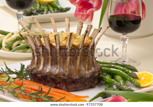 Crown roast of lamb with apple
rosemary stuffing. Garnished with asparagus, glazed carrots, and
rosemary twigs. Side dishes - asparagus, and
beans.