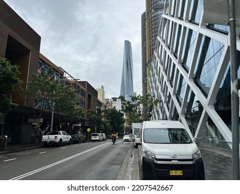 Crown Sydney Tower In Central Business District Of Sydney City In Australia On 23 September 2022. Cars Vehicles Parked On Street With Buildings. One Person In N Motorbike On Road.