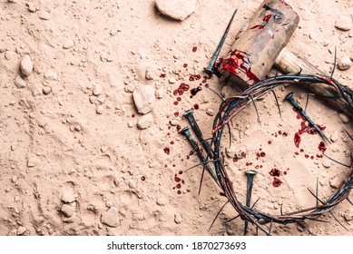 Crown of thorns, hammer, bloody nails on ground. Good Friday, Passion of Jesus Christ. Christian Easter holiday. Top view, copy space. Crucifixion, resurrection of Jesus Christ. Gospel, salvation.