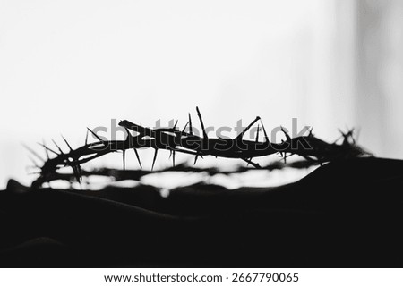 Crown of thorns on white table background. Easter, central celebration in Christianity, honors sacrifice of Jesus Christ, crown of thorns symbolizes redemption, faith, deep spirituality of religion.