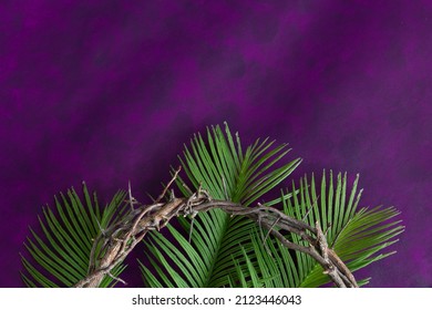 Crown of thorns and palm leaves border on a dark purple background with copy space