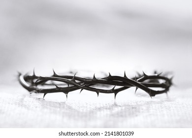 Crown of thorns symbolizing the sacrifice, suffering and resurrection of Jesus Christ on the cross and Easter light background

